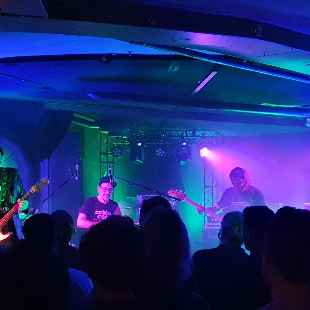 A band performing on stage in a concert venue.